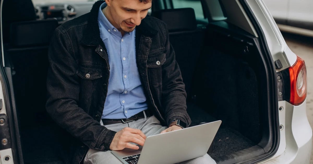 man in vehicle on tablet